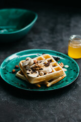 Sweet Belgian waffles with banana and chocolate and nuts