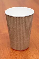 three empty cardboard cups on a wooden background
