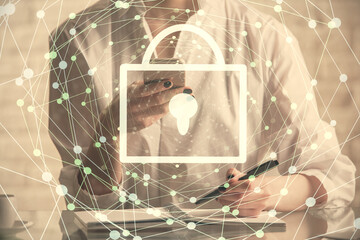 Double exposure of lock sketch hologram and woman holding and using a mobile device. Security iT...