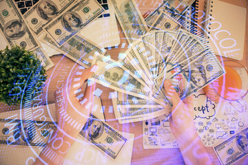 Multi exposure of technology drawing hologram and us dollars bills and man hands. Data concept