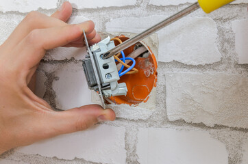 Electrician working repairing a switch in an apartment
