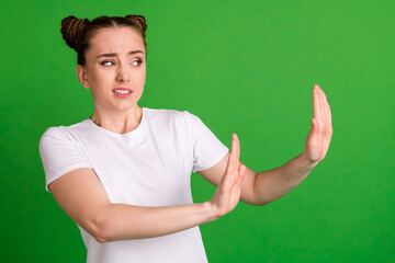 Photo portrait of curious annoyed girl refusing ignoring grimacing isolated on vivid green color...