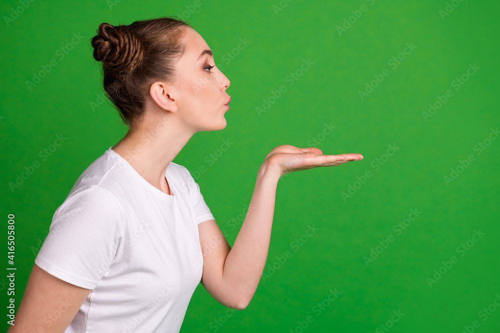 Sticker Profile photo of lovely lady hold palm blow air kiss look empty space wear white t-shirt isolated green background