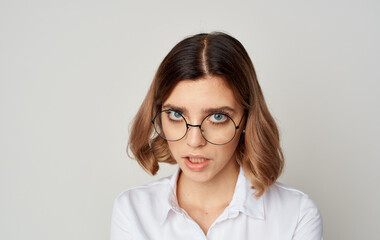 Fototapeta premium Beautiful woman wearing glasses short hair white shirt and beige background