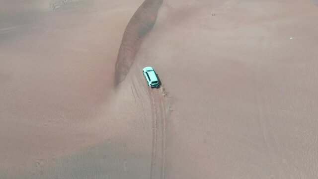Car driving in the dessert of Dubai.