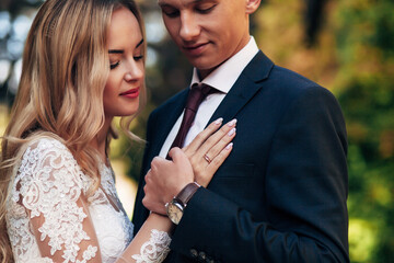 newlyweds walk in a beautiful park