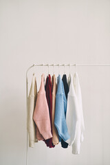 multicolored women's woolen sweaters on hangers. Sale in a fashion store