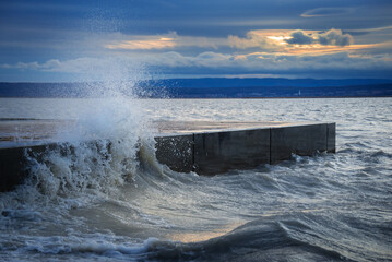 Crashing wave on the pier of Illmitz on Lake Neusiedlersee in Burgenland Austria