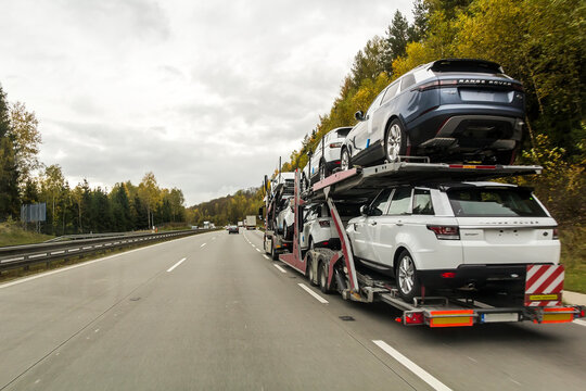 Rothenburg ob der Tauber, Germany - October 12, 2017: The trailer truck transports brand new cars on highway.