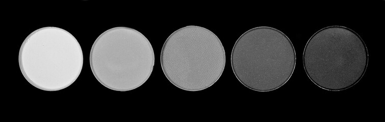Makeup palette with shades of grey background and texture, top view