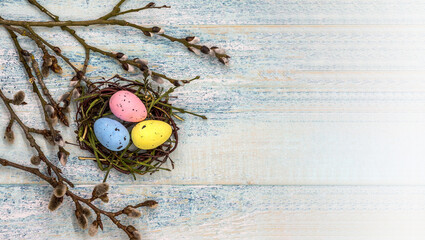 Obraz na płótnie Canvas Happy Easter. Willow twigs. Holy Easter. Blue turquoise background. Easter eggs in the nest.