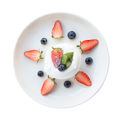 Top view Close-up, Japanese-style pancake topped with mixed fruits, strawberries, kiwi, and blueberries on the top of a cake placed isolated on white background.