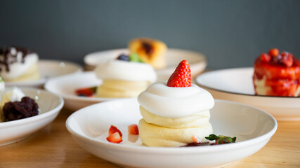 Japanese-style pancakes on a wooden table are ready to serve.