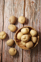 Fresh raw potatoes on a wooden background