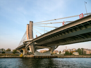 Fototapeta premium Modern design concrete bridge support over water. The highway over the head. Saint Petersburg.