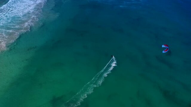 Kiter riding in the blue ocean.