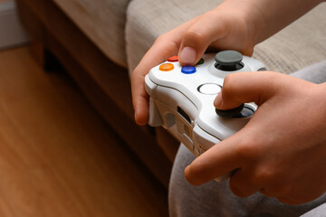 two hand holding video game console controller