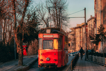 Old nostalgic tram going through the streets of Kadikoy on the Asian side of Istanbul. Sunset view. 