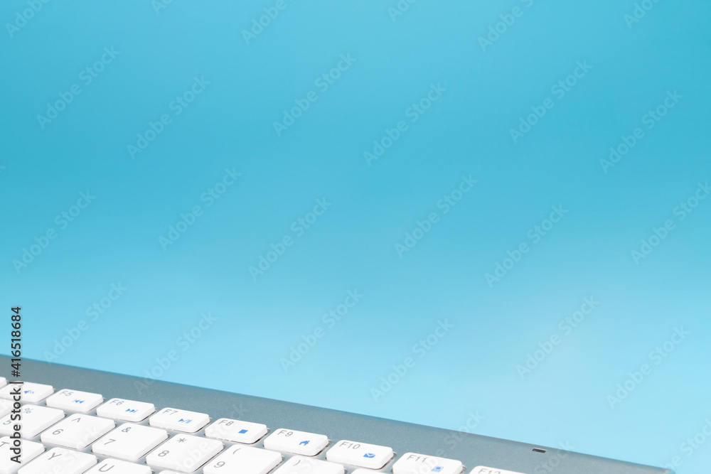 Fototapete wireless keyboard with copy space on blue background. computer or tablet keyboard with copy space fo