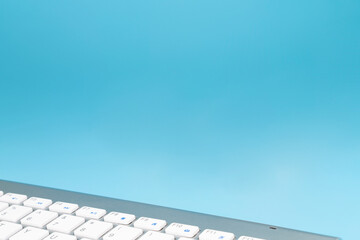 Wireless keyboard with copy space on blue background. Computer or Tablet keyboard with copy space...