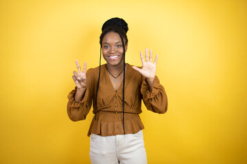 African american woman wearing casual clothes showing and pointing up with fingers number seven...