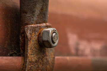 Rust damage paint and corrosion flange on the roof tank. plumbing iron pipes, industry, manufacture of iron pipes. oxidation rust full of oil pipeline, closeup of photo


