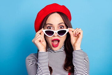 Photo portrait of pretty girl surprised amazed in sunglass opened mouth isolated vivid blue color...