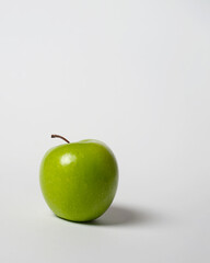 Two green apples and one red apple isolated on white background. With a wooden base in the shape of love. Capture from above. Apples contain vitamin C. Apples, including fruits that are rich in fiber.