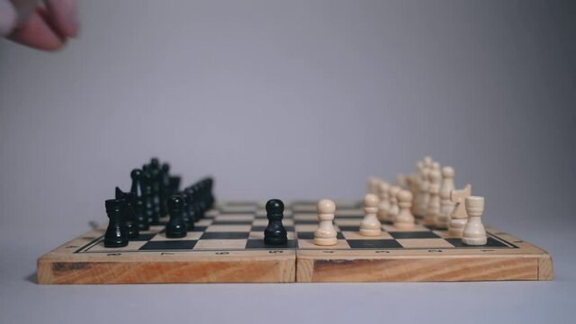 Two people play on a chessboard, a woman and a man move pawns in sequence