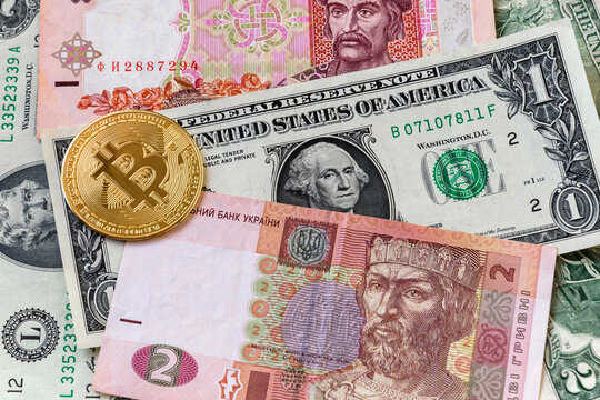 New virtual money on Ukraine banknotes close up image of bitcoins with Ukraine hryvnia banknotes