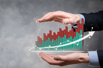 Businessman hold drawing on screen growing graph, arrow of positive growth icon.pointing at creative business chart with upward arrows.Financial, business growth concept.
