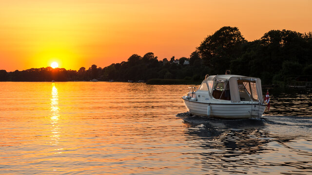 The area around Silkeborg is breathtaking - especially at sunset. The people on this small boat enjoys the view and the colours of the setting sun.