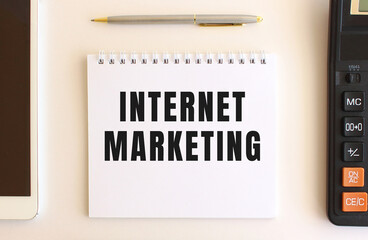 Notepad with text INTERNET MARKETING on a white background. Business concept.