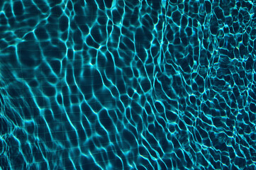 Blue water in swimming pool with sun reflection