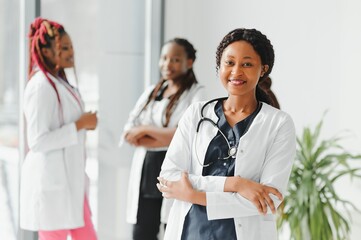 health care, profession, people and medicine concept - happy african american female doctor or...