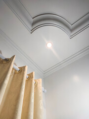 plaster ceiling in living room with soft colored curtain.