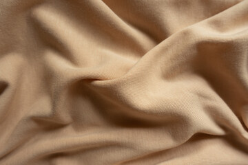 Beige cotton jersey fabric in soft folds