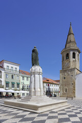 Fototapeta na wymiar Saint John the Baptist Church, Gualdim Pais statue on Republic square, Tomar, Santarem district, Portugal