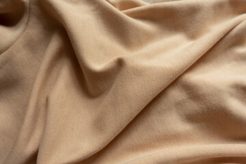 Jammed simple beige cotton jersey fabric from above