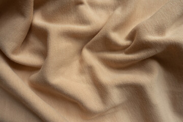 Rippled simple beige cotton jersey fabric from above
