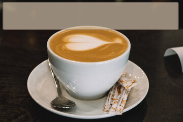 Mug of coffee is on the table latte art in the shape of a heart