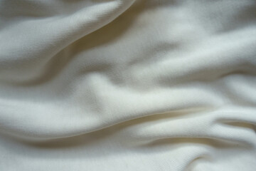 Folded simple white cotton jersey fabric from above