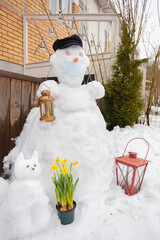 In the courtyard of the house there is a snowman in a medical mask.
Concept, spring, protect...