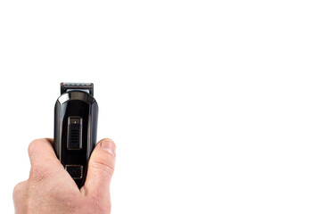 Hand with electric trimmer close up. Hair cut machine isolated on white with copy space.