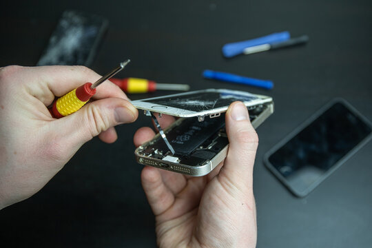 Broken Iphone. Screen cracked mobilephone. Repairing  Iphone smartphone. Replacing screen and battery