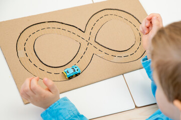 Corrugated carton race track. follow the lines. Implement for children or people with disabilities...