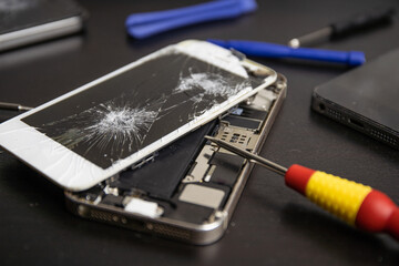 Screen cracked smartphone. Mobile phone with damaged touchscreen. Repairing smartphone. Replacing...