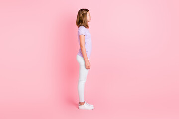 Fototapeta na wymiar Full length profile side photo of serious charming little girl wear casual outfit isolated on pastel pink color background