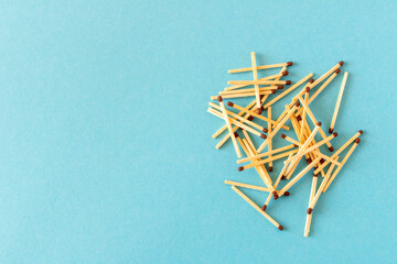 Lots of matches on a blue background. The concept of chaos and order. Selective focus.
