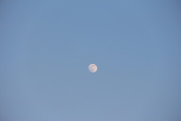 the moon against a blue sky